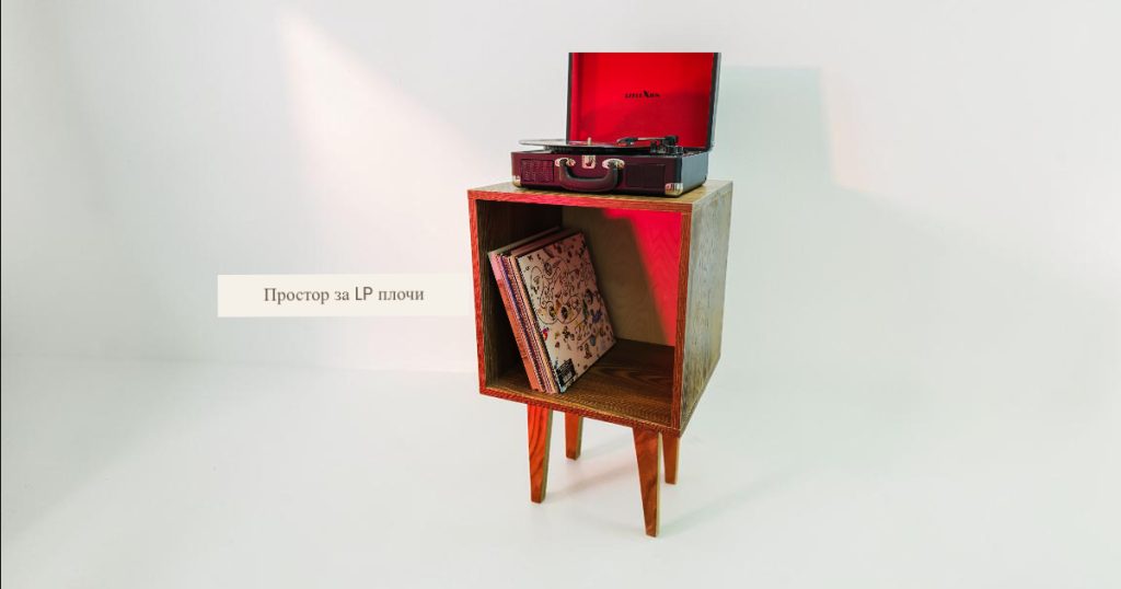 Wooden cube-style cabinet with a turntable on top and LPs stored inside the lower compartment, set against a pale background.